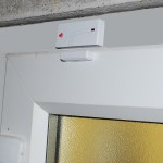Wireless Magnetic Contact fitted onto a PVC Door.